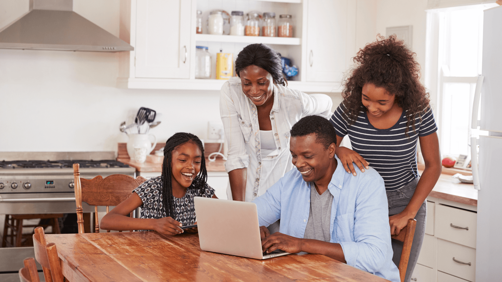 Family looking at laptop